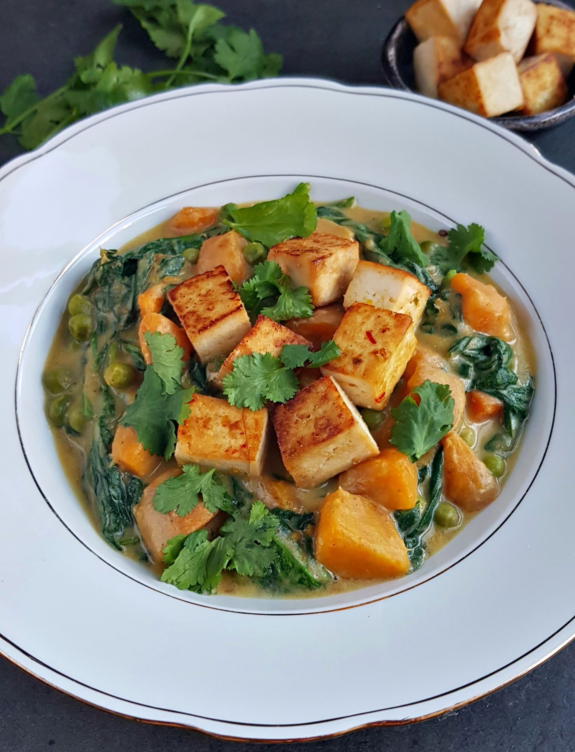 Sweet potato curry with tofu, spinach and green peas