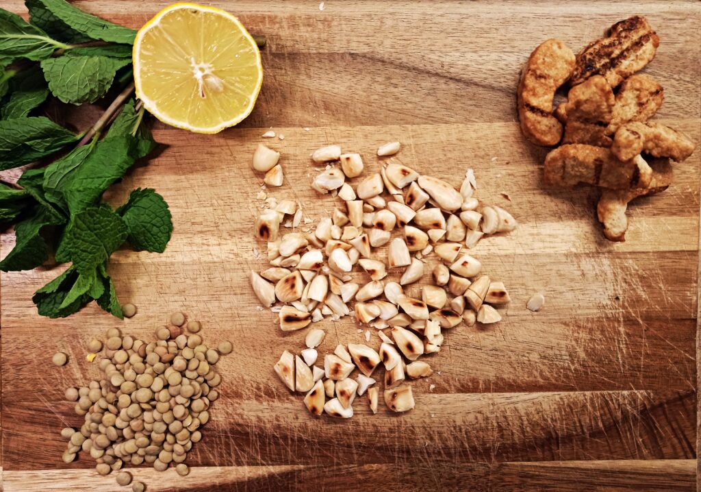 ingredients for lentil salad: almonds, brown lentils, fresh mint, and lemon