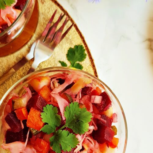 Vegetable root salad with potatoes, beetroot, carrots, onion, and sauerkraut