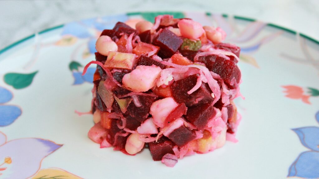 beetroot salad recipe with potatoes, carrots, white beans, sauerkraut, and cournichons