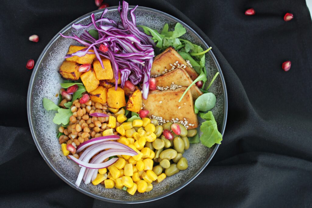 plant power bowl: tofu, edamame, sweet corn, red onion, purple cabbage, pumpkin, lentils, tahini