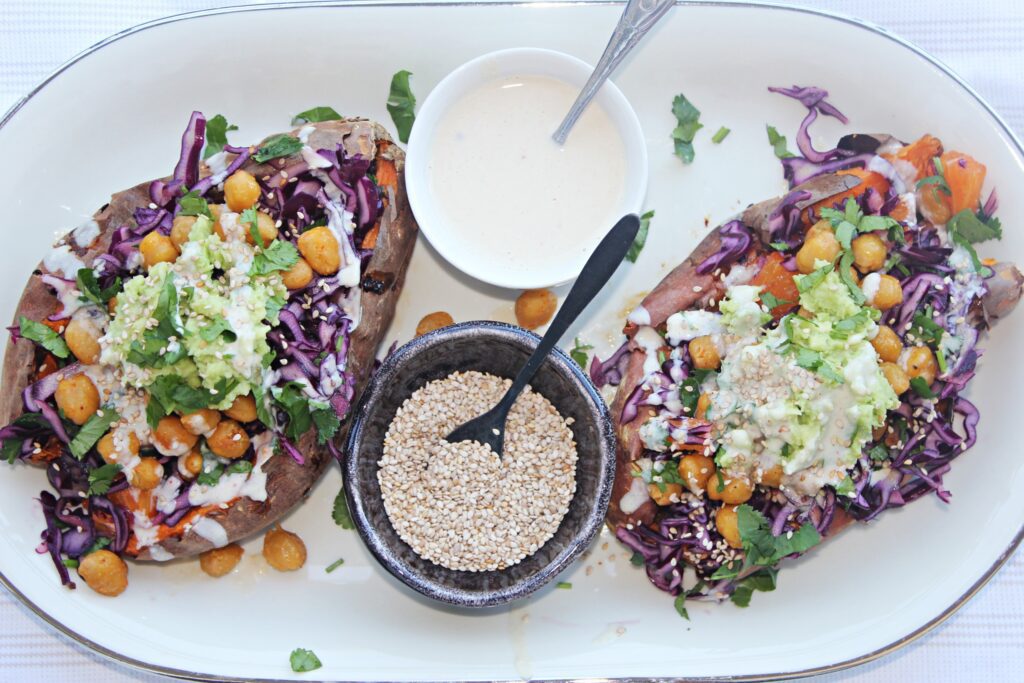 stuffed sweet potatoes with chickpeas, red cabbage and orange