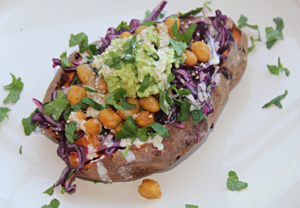 stuffed sweet potatoes with chickpeas, red cabbage and orange