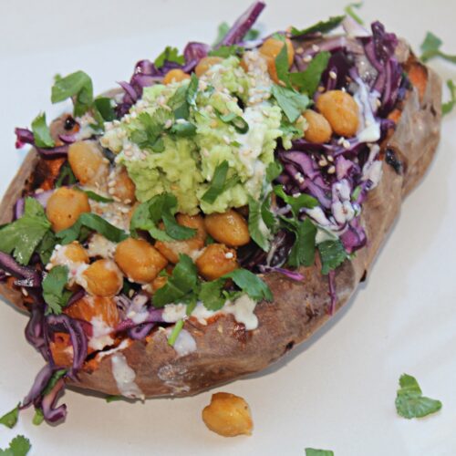 stuffed sweet potatoes with chickpeas, red cabbage and orange