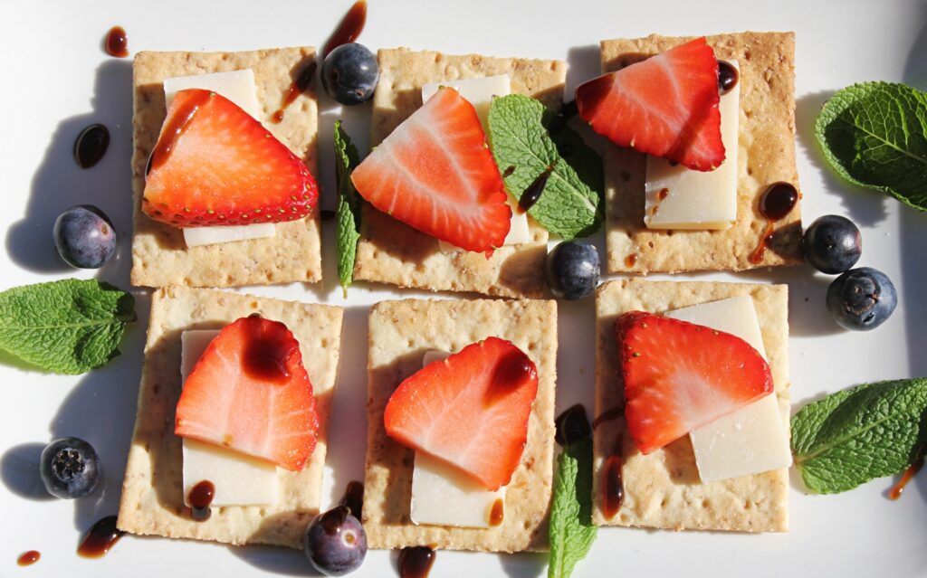 guilt-free snacks: crackers with cheese and strawberries
